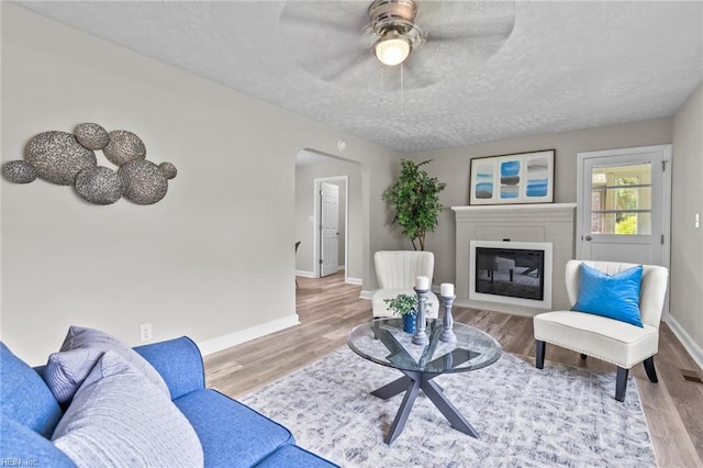 1309 Wickham Ave, Newport News, VA 23607 - living area with wood finished floors, a textured ceiling, ceiling fan, and arched walkways