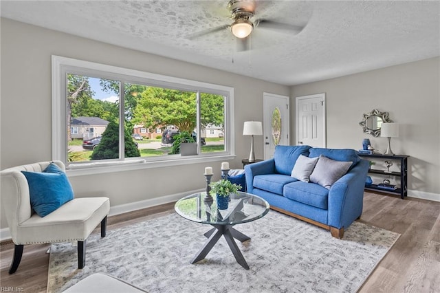 1309 Wickham Ave, Newport News, VA 23607 - living area featuring a textured ceiling, ceiling fan, and wood finished floors