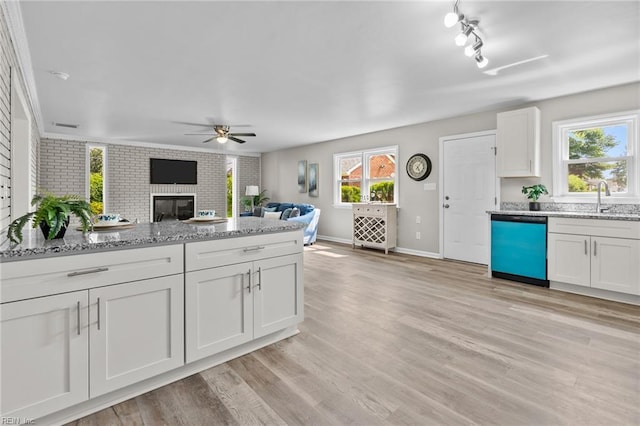 1309 Wickham Ave, Newport News, VA 23607 - kitchen featuring dishwashing machine, a ceiling fan, white cabinetry, a fireplace, and open floor plan