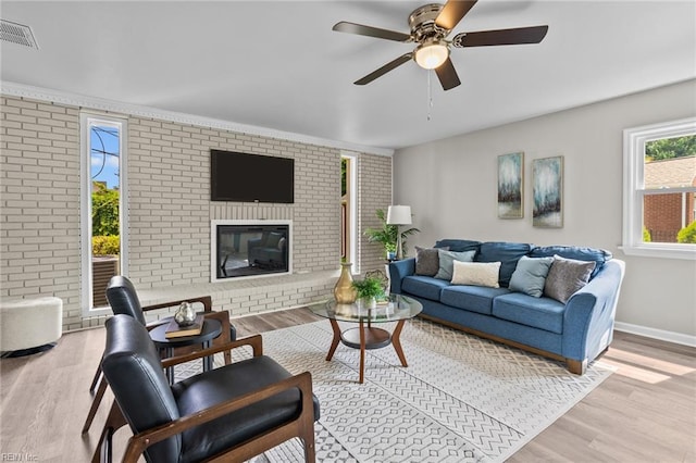 1309 Wickham Ave, Newport News, VA 23607 - living area featuring brick wall, wood finished floors, a ceiling fan, and a fireplace