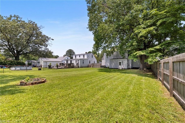 4825 Robin Hood Rd, Norfolk, VA 23513 - fenced backyard featuring a fire pit and a shed