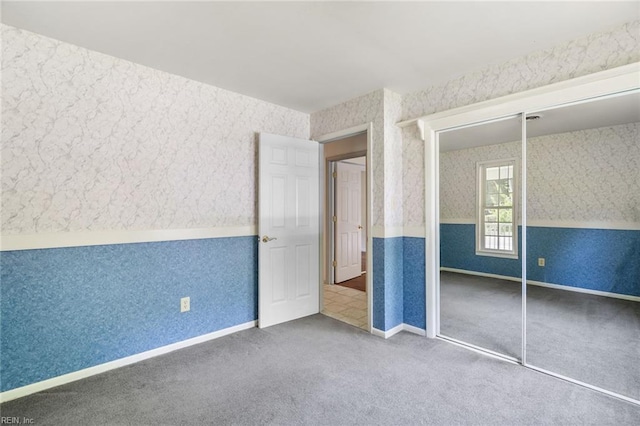 318 Hearthstone Way, Newport News, VA 23608 - unfurnished bedroom with wallpapered walls, carpet floors, and a closet