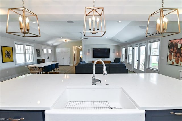 5227 Lake Shores Rd, Virginia Beach, VA 23455 - kitchen with a chandelier, open floor plan, vaulted ceiling, light countertops, and hanging light fixtures