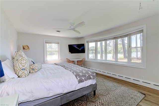 5227 Lake Shores Rd, Virginia Beach, VA 23455 - bedroom with a baseboard heating unit, multiple windows, and wood finished floors