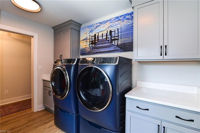 5227 Lake Shores Rd, Virginia Beach, VA 23455 - washroom featuring independent washer and dryer, cabinet space, and light wood-style flooring