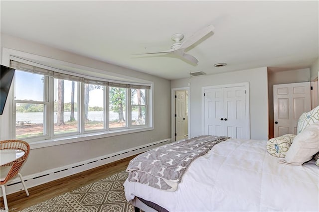 5227 Lake Shores Rd, Virginia Beach, VA 23455 - bedroom featuring a baseboard heating unit, wood finished floors, a closet, and ceiling fan