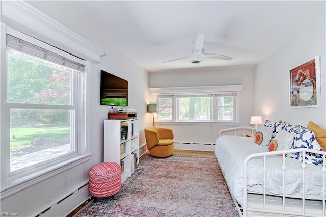 5227 Lake Shores Rd, Virginia Beach, VA 23455 - bedroom featuring a baseboard heating unit, wood finished floors, a ceiling fan, and a baseboard radiator