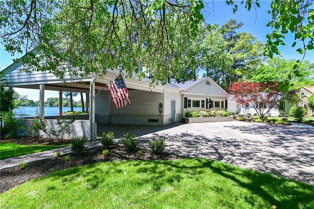 5227 Lake Shores Rd, Virginia Beach, VA 23455 - view of front of house with driveway, a water view, a front lawn, and an attached carport