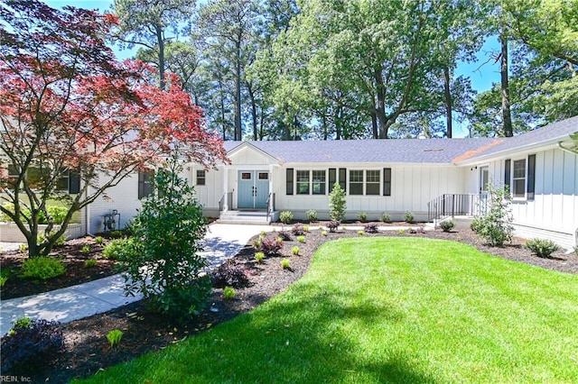5227 Lake Shores Rd, Virginia Beach, VA 23455 - ranch-style house with board and batten siding, a front yard, and a shingled roof