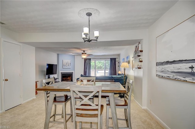 1118 Glengarry Way, Virginia Beach, VA 23451 - dining area with a ceiling fan, a warm lit fireplace, light carpet, and a chandelier