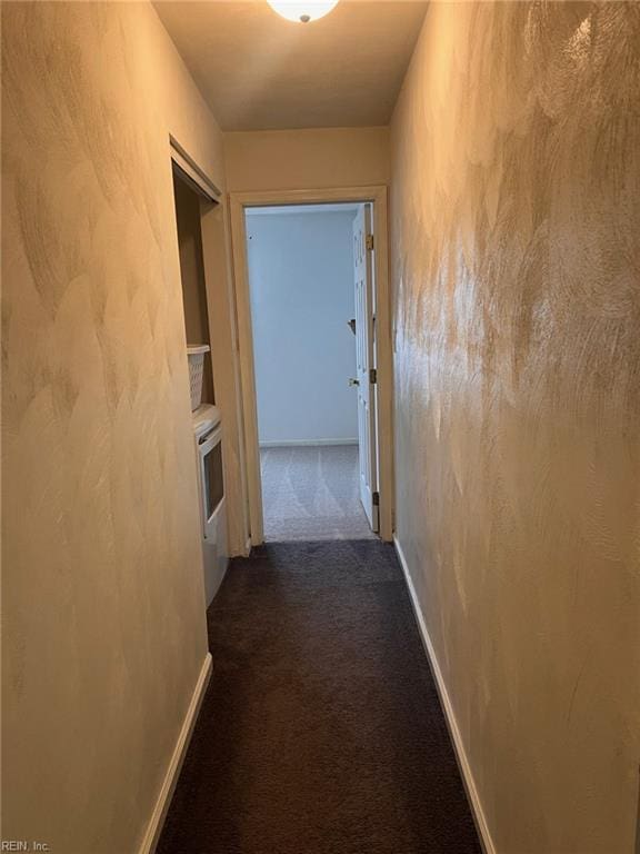 222 Greenfield Cres, Suffolk, VA 23434 - hallway with dark colored carpet, washer / clothes dryer, and baseboards