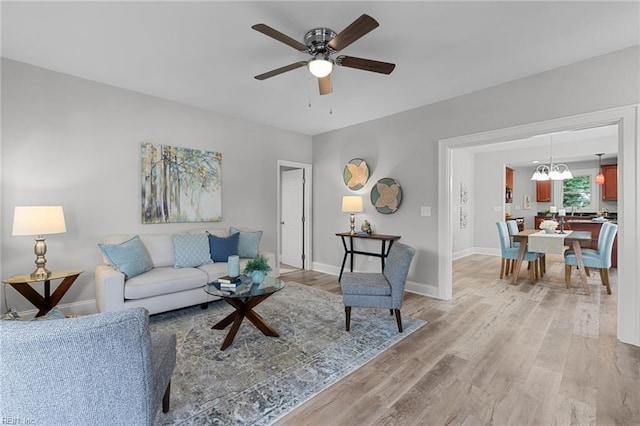 2724 Kimball Ter, Norfolk, VA 23504 - living room featuring light wood-style flooring, ceiling fan, and a chandelier