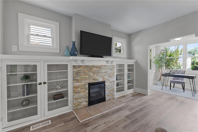 2724 Kimball Ter, Norfolk, VA 23504 - living area featuring plenty of natural light, wood finished floors, and a stone fireplace