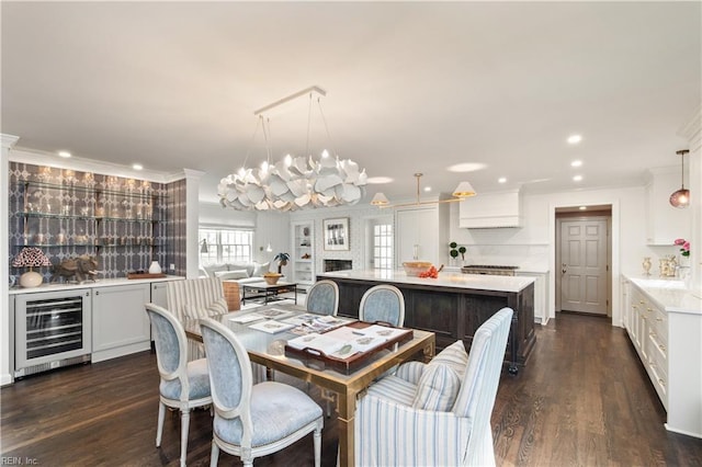 209 44th St, Virginia Beach, VA 23451 - dining room with beverage cooler, ornamental molding, dark wood finished floors, a chandelier, and a dry bar