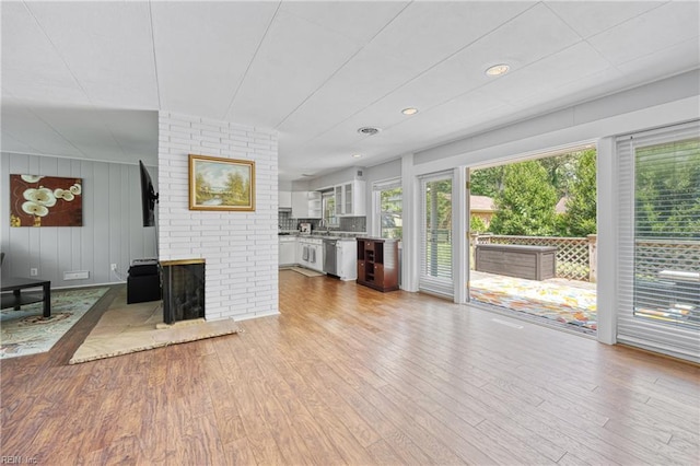 2 Sir Francis Wyatt Pl, Newport News, VA 23606 - unfurnished living room with light wood-style flooring, recessed lighting, and a fireplace