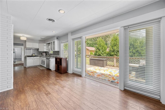 2 Sir Francis Wyatt Pl, Newport News, VA 23606 - kitchen featuring white cabinetry, dark wood-style floors, backsplash, and stainless steel dishwasher