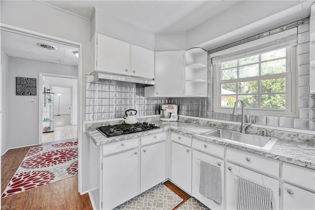 2 Sir Francis Wyatt Pl, Newport News, VA 23606 - kitchen with black gas stovetop, under cabinet range hood, dark wood-style flooring, white cabinetry, and open shelves