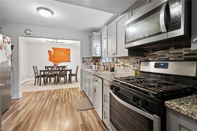 3621 S Warwick Cir, Norfolk, VA 23513 - kitchen featuring stainless steel appliances, light wood-type flooring, decorative backsplash, and light stone countertops