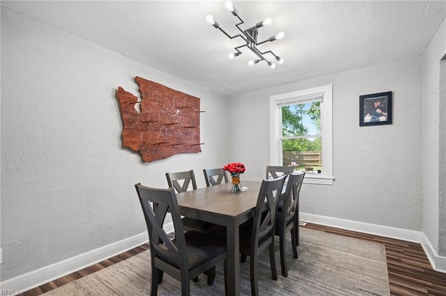 3621 S Warwick Cir, Norfolk, VA 23513 - dining space with wood finished floors, a textured wall, and a textured ceiling