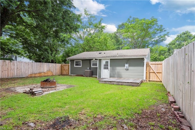 504 Day St, Hampton, VA 23661 - rear view of house featuring an outdoor fire pit, a wooden deck, a fenced backyard, and a gate