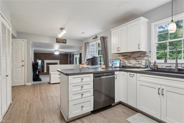 155 Wilderness Rd, Hampton, VA 23669 - kitchen featuring stainless steel dishwasher, a peninsula, light wood finished floors, white cabinets, and dark countertops