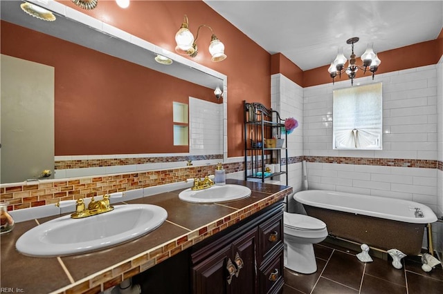 1236 Ginger Crst, Virginia Beach, VA 23453 - bathroom featuring tile patterned floors, a freestanding tub, tile walls, double vanity, and a chandelier