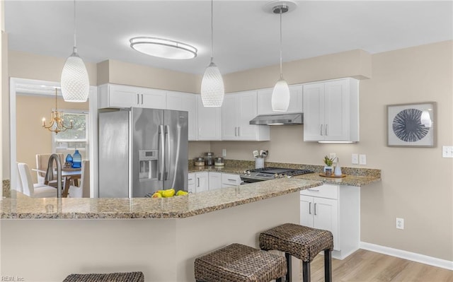 1304 Glen Burnie Ct, Virginia Beach, VA 23454 - kitchen with stainless steel appliances, white cabinets, a breakfast bar, light wood-style floors, and light stone countertops