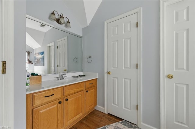 418 Rolling Hills Dr, Williamsburg, VA 23185 - bathroom featuring lofted ceiling, vanity, and wood finished floors