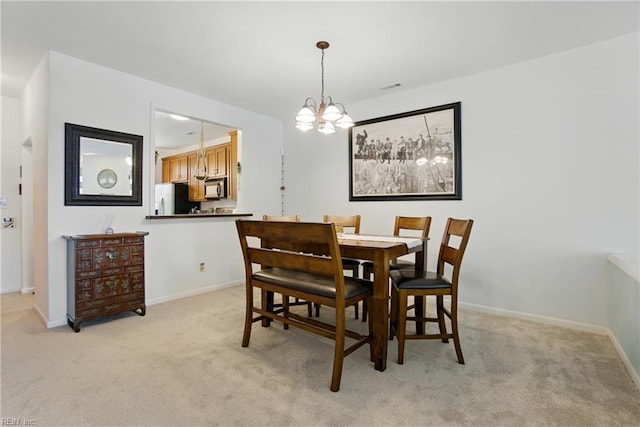 1039 Little Bay Ave, Norfolk, VA 23503 - dining space featuring light colored carpet and a chandelier