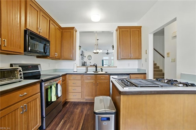 1039 Little Bay Ave, Norfolk, VA 23503 - kitchen featuring stainless steel appliances, dark wood-style floors, brown cabinets, and a chandelier