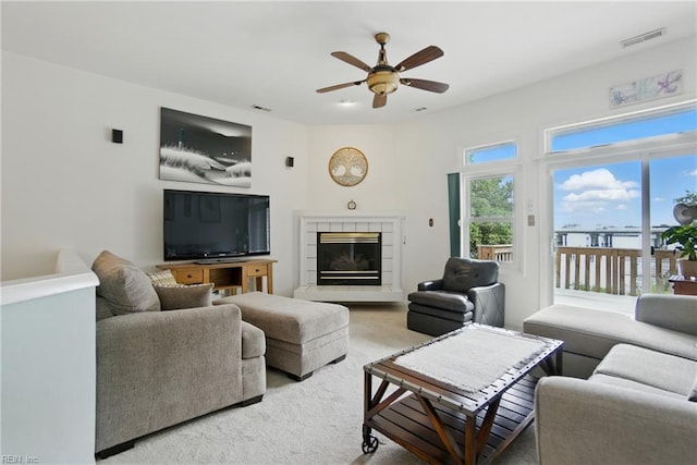 1039 Little Bay Ave, Norfolk, VA 23503 - carpeted living room with a ceiling fan and a tile fireplace