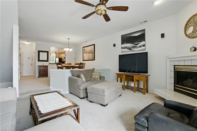 1039 Little Bay Ave, Norfolk, VA 23503 - living room featuring carpet flooring, ceiling fan, a chandelier, and a tiled fireplace
