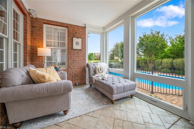 6003 Spinnaker Cove Ct, Suffolk, VA 23435 - sunroom featuring stone tile floors, healthy amount of natural light, and brick wall