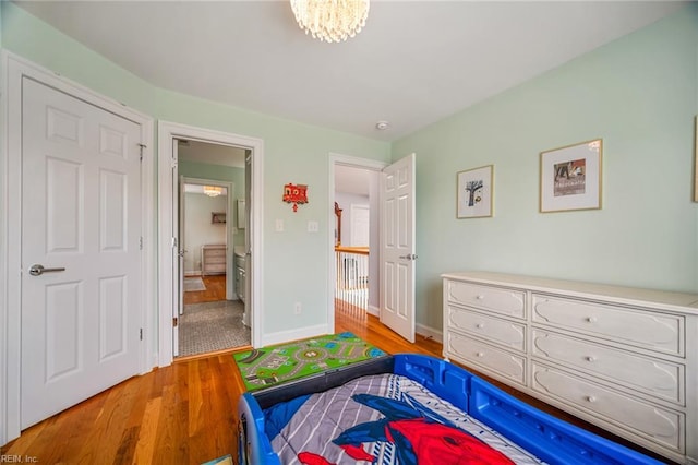 6003 Spinnaker Cove Ct, Suffolk, VA 23435 - bedroom with wood finished floors, ensuite bathroom, and a chandelier
