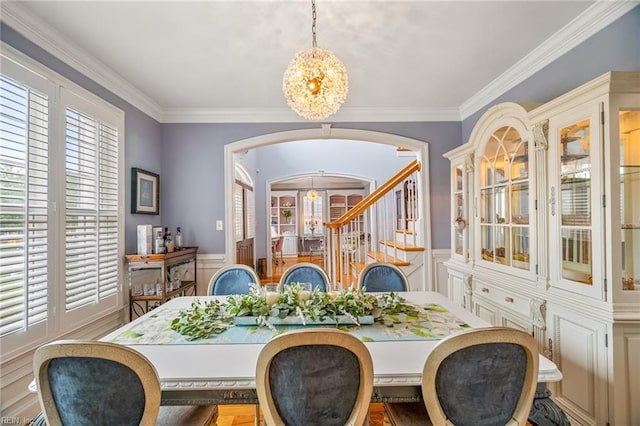6003 Spinnaker Cove Ct, Suffolk, VA 23435 - dining room with a chandelier, arched walkways, a decorative wall, ornamental molding, and wainscoting