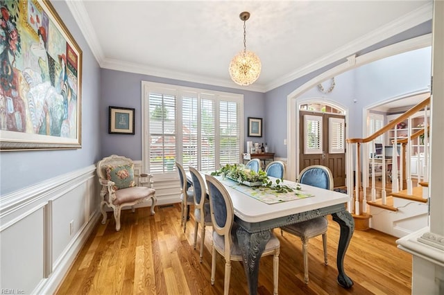 6003 Spinnaker Cove Ct, Suffolk, VA 23435 - dining space with light wood finished floors, stairway, ornamental molding, a wainscoted wall, and a chandelier