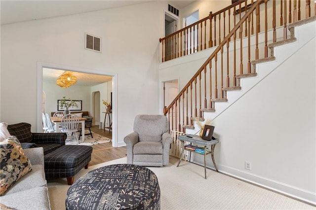 55 Brogden Ln, Hampton, VA 23666 - living room with stairway, arched walkways, high vaulted ceiling, wood finished floors, and a chandelier