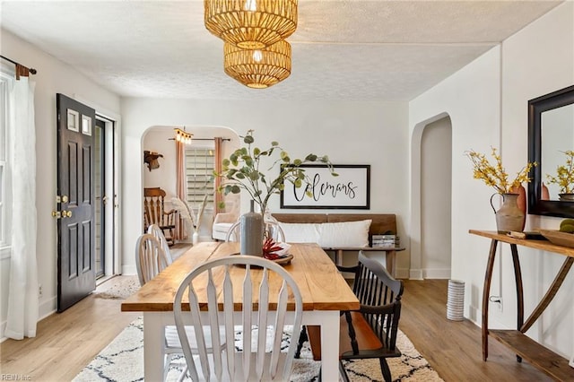 55 Brogden Ln, Hampton, VA 23666 - dining space with arched walkways, light wood-style floors, and a textured ceiling