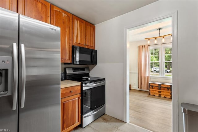 55 Brogden Ln, Hampton, VA 23666 - kitchen featuring stainless steel appliances, brown cabinetry, and light countertops