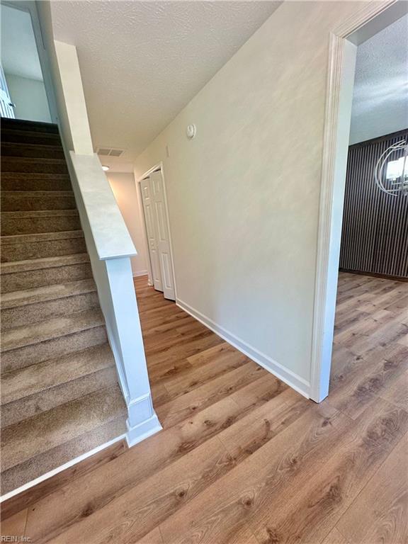 39 Rotherham Ln, Hampton, VA 23666 - stairway with wood finished floors and a textured ceiling