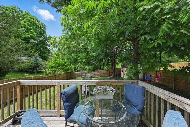 321 Pinner St, Suffolk, VA 23434 - deck featuring a fenced backyard, a storage unit, and outdoor dining space