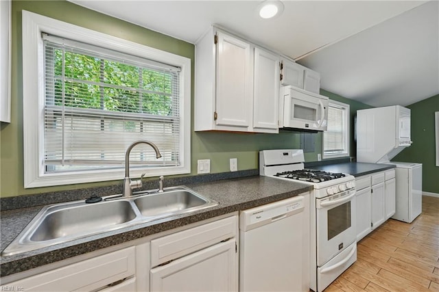 9001 Tidewater Dr, Norfolk, VA 23503 - kitchen featuring white appliances, dark countertops, white cabinetry, light wood-style floors, and lofted ceiling