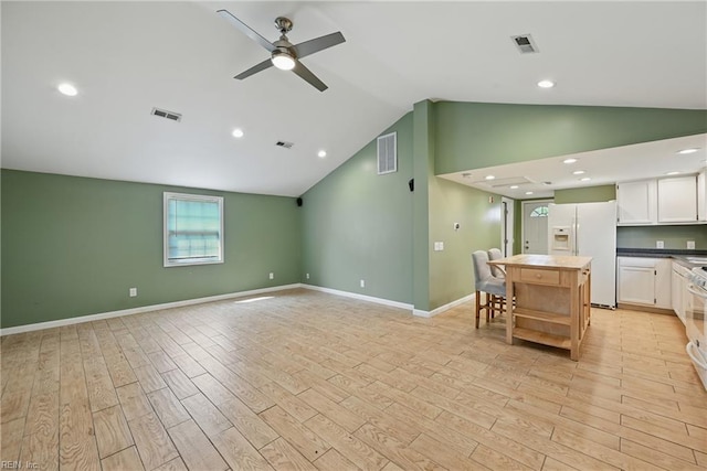 9001 Tidewater Dr, Norfolk, VA 23503 - kitchen featuring white refrigerator with ice dispenser, vaulted ceiling, light wood-style flooring, ceiling fan, and white cabinetry