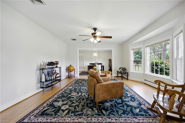 2400 Deerfield Cres, Chesapeake, VA 23321 - living room with wood finished floors, a ceiling fan, and a baseboard radiator