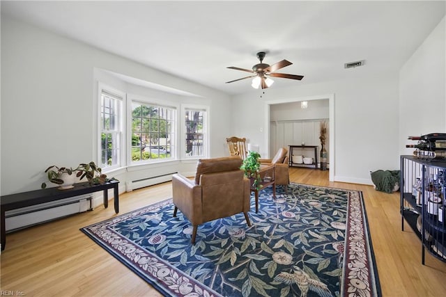 2400 Deerfield Cres, Chesapeake, VA 23321 - living area with a ceiling fan, wood finished floors, a baseboard heating unit, and a baseboard radiator