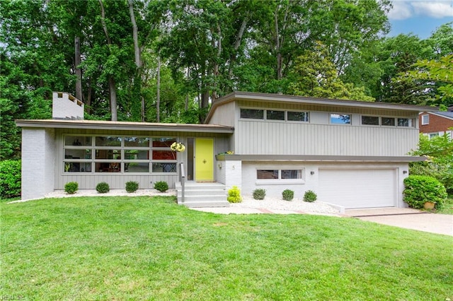 5 Downing Pl, Newport News, VA 23606 - tri-level home featuring concrete driveway, a garage, a front yard, and a chimney