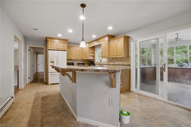 709 Wolfsnare Cres, Virginia Beach, VA 23454 - kitchen featuring a baseboard heating unit, white fridge with ice dispenser, a kitchen breakfast bar, tasteful backsplash, and a center island