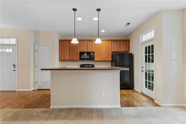 2741 Deep Creek Cmn, Chesapeake, VA 23323 - kitchen with black appliances, brown cabinets, pendant lighting, light wood-style flooring, and recessed lighting