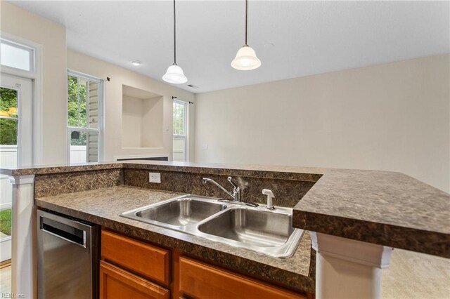 2741 Deep Creek Cmn, Chesapeake, VA 23323 - kitchen with dark countertops, stainless steel dishwasher, decorative light fixtures, and brown cabinets