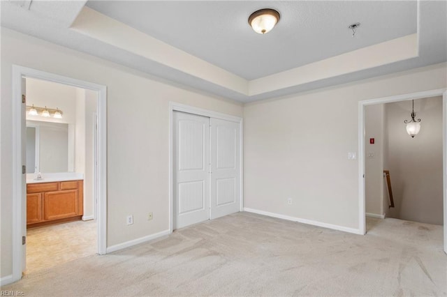 2741 Deep Creek Cmn, Chesapeake, VA 23323 - unfurnished bedroom with light carpet, a tray ceiling, a closet, and connected bathroom